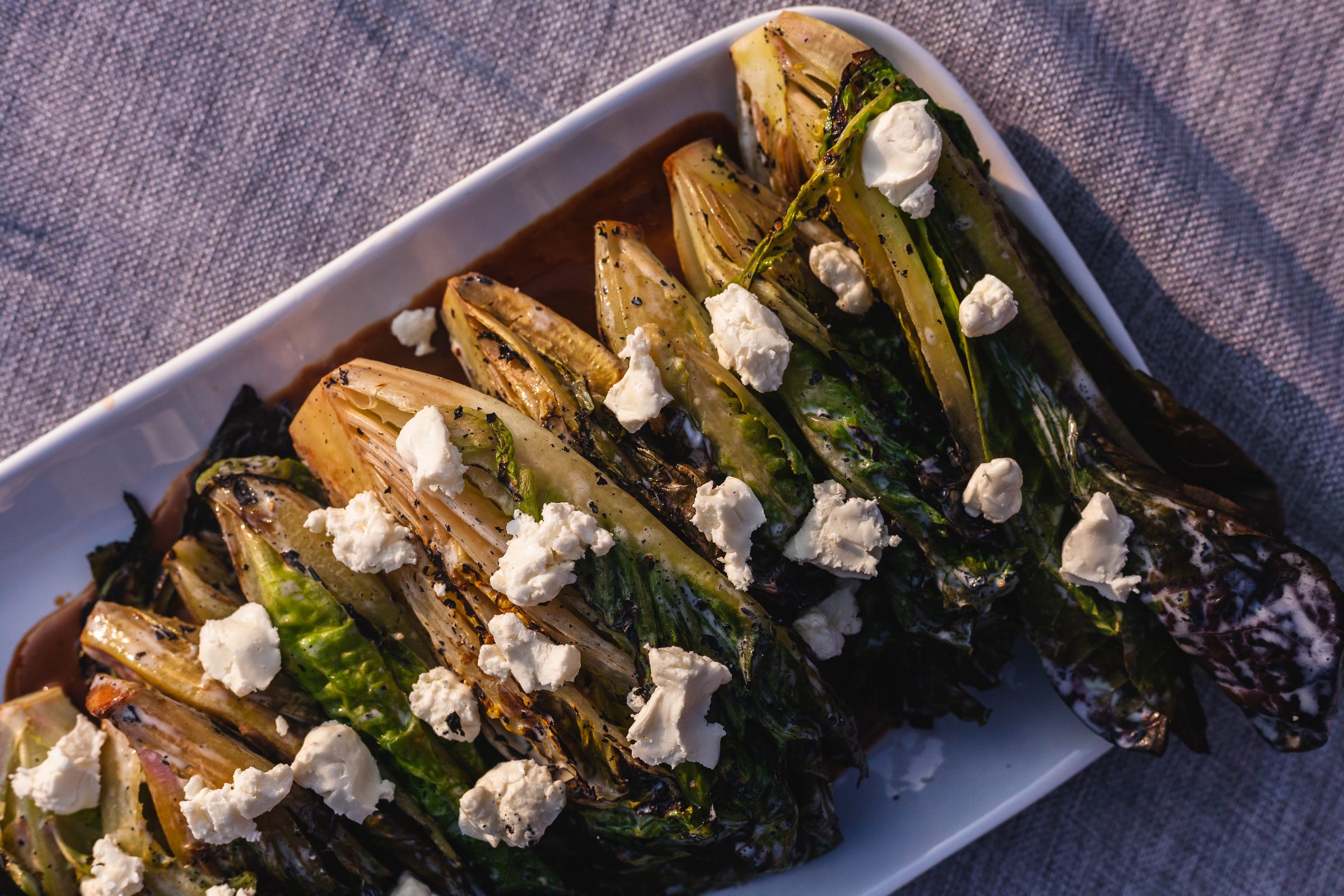 A plated dish of grilled greens and chèvre