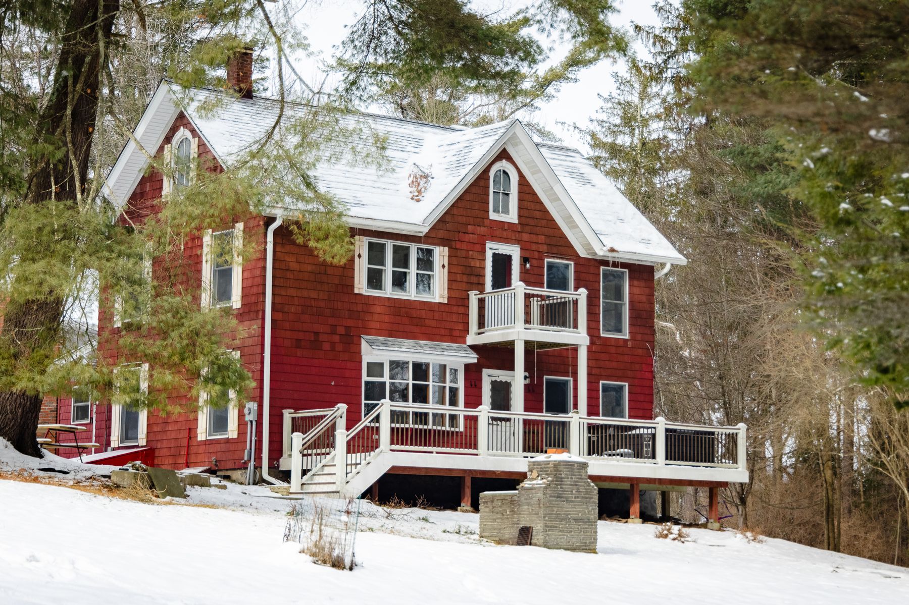 The red shingle farmhouse in snow
